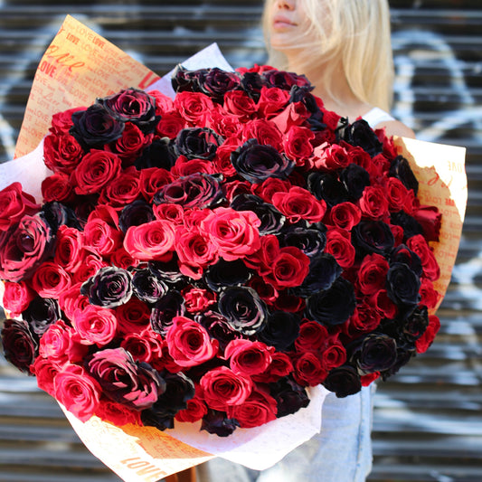 Luxurious mix of deep red and black roses in a grand arrangement, ideal for romantic gestures and premium delivery
