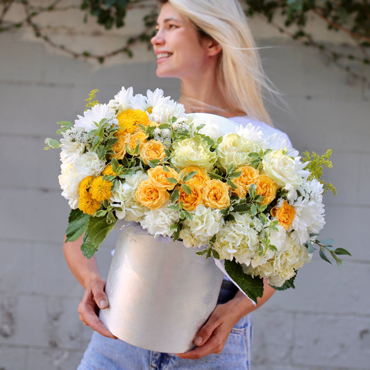 Vibrant yellow and white floral arrangement styled for premium delivery, perfect for birthdays and sentimental occasions