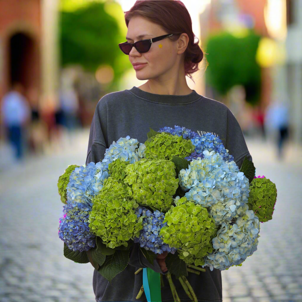 Elegant bouquet of blue hydrangeas and white roses, ideal for serene celebrations