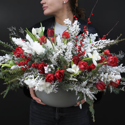 Elegant bouquet of white roses with seasonal greenery, symbolizing purity and winter charm