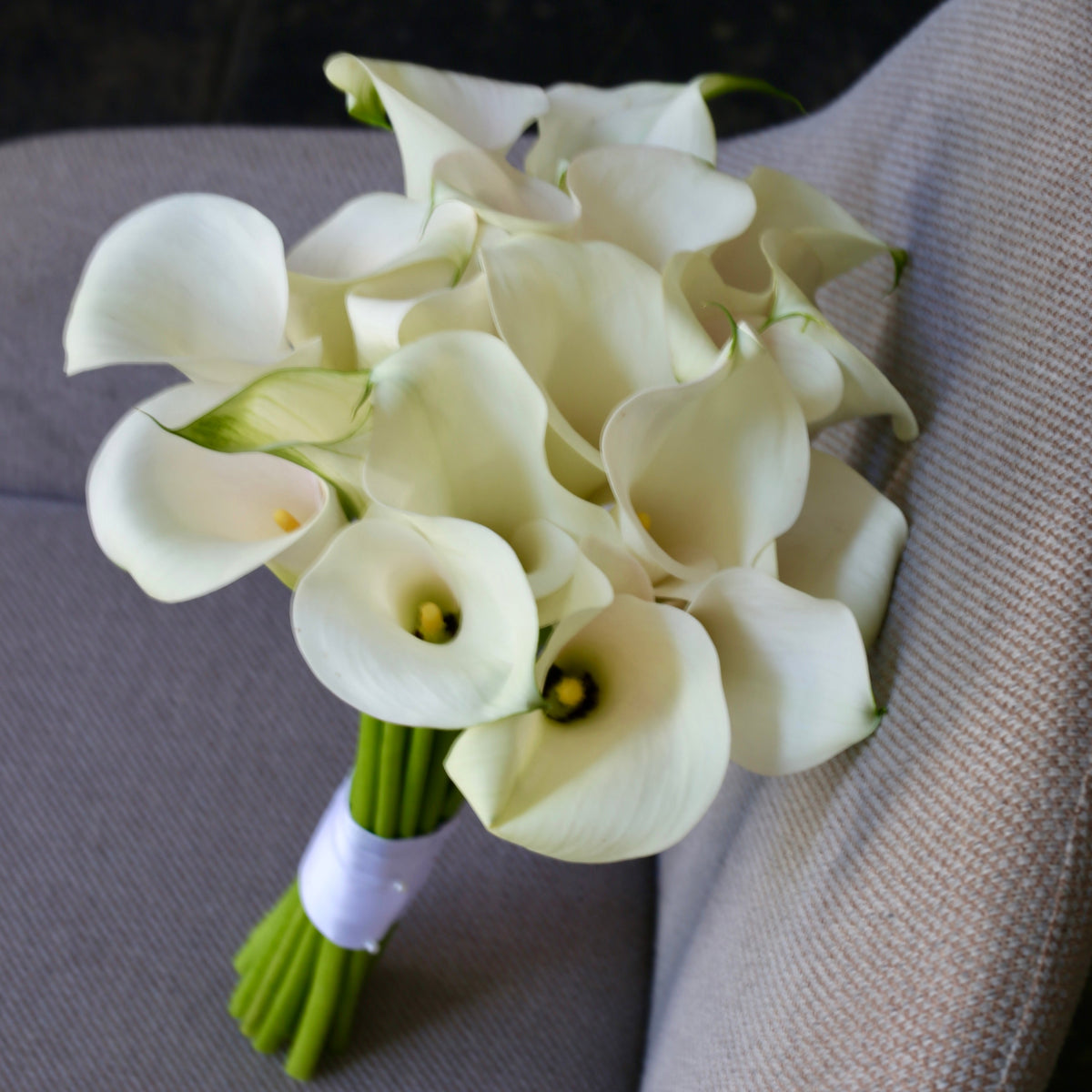 Elegant bouquet of white roses with soft green accents, ideal for serene celebrations