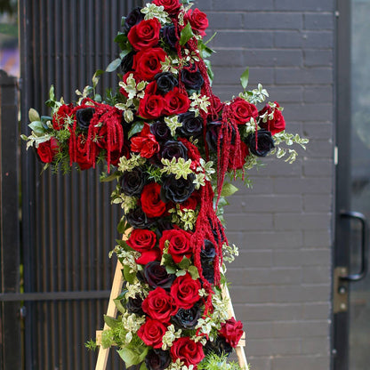 Handcrafted sympathy arrangement showcasing a floral cross design, ideal for honoring cherished memories