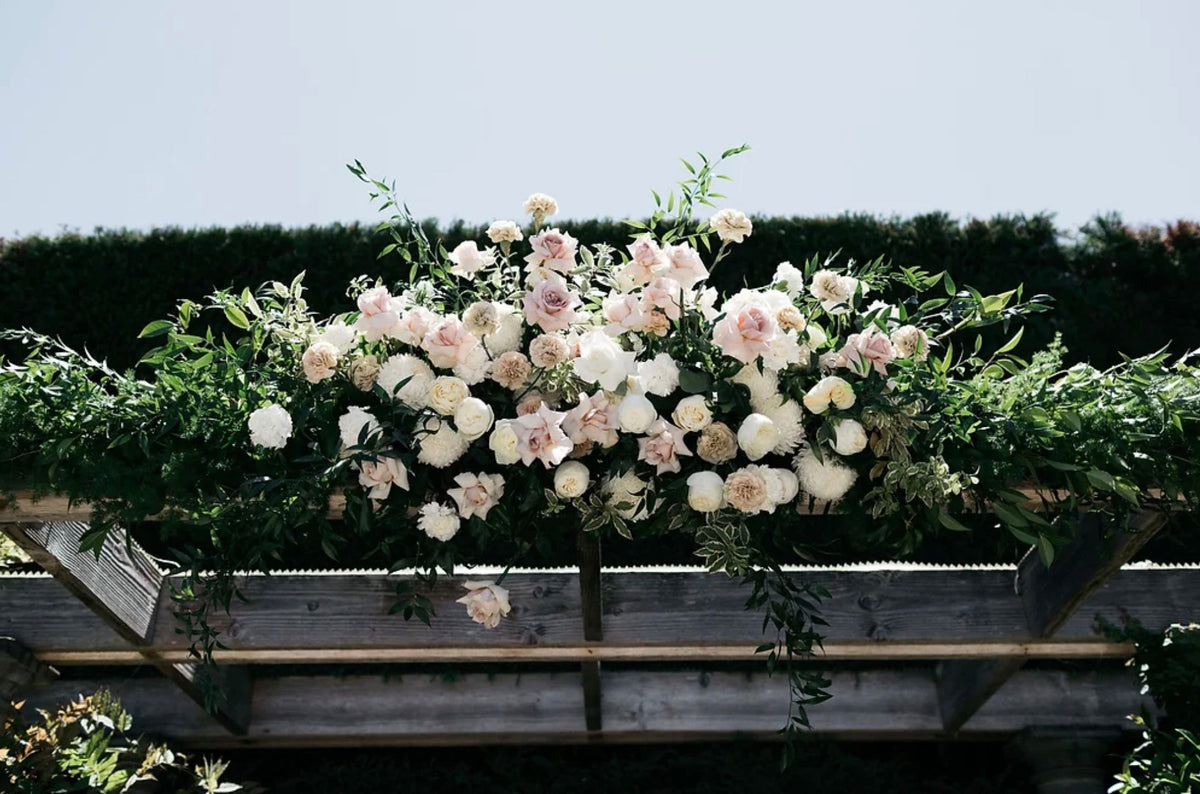 Artisan-crafted Flower Clouds Arch featuring cascading blooms and lush greenery for luxury weddings