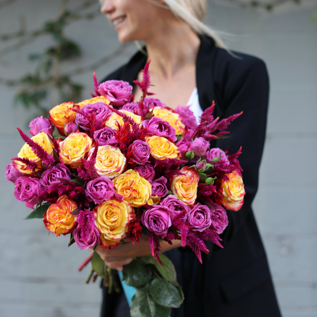 Handcrafted floral gift showcasing fresh purple and yellow roses, styled for a joyful and refined presentation