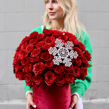 Luxurious red rose arrangement in a decorative Christmas box, ideal for holiday gifting and romantic surprises