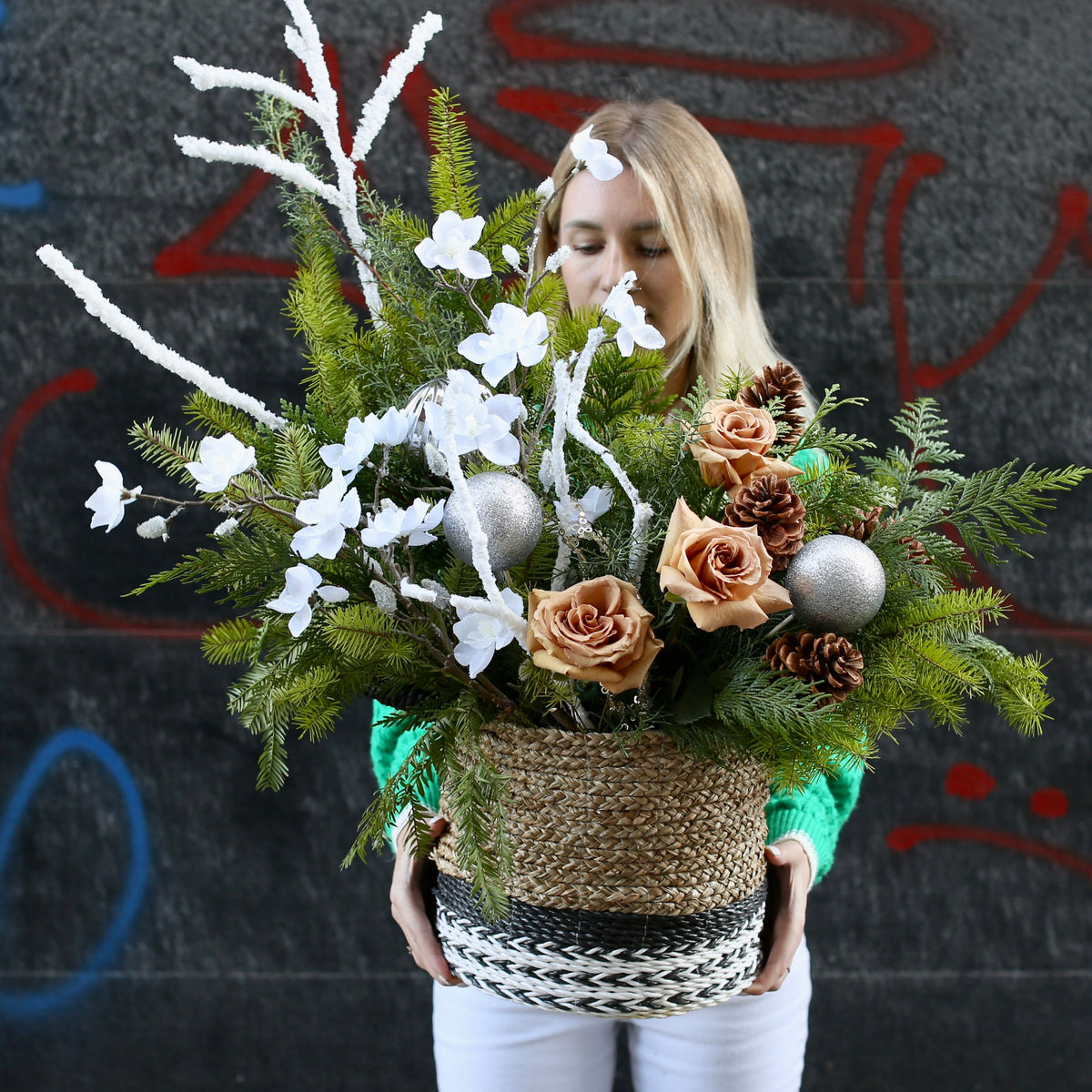 Elegant Christmas tree decorated with white roses, pinecones and festive natural accents for a luxurious holiday look