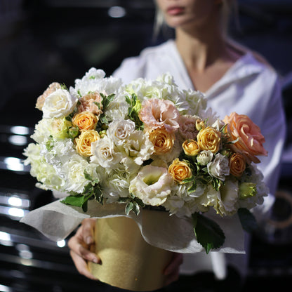 Elegant floral arrangement in a gold decorative box featuring white and yellow roses, ideal for birthdays and special celebrations