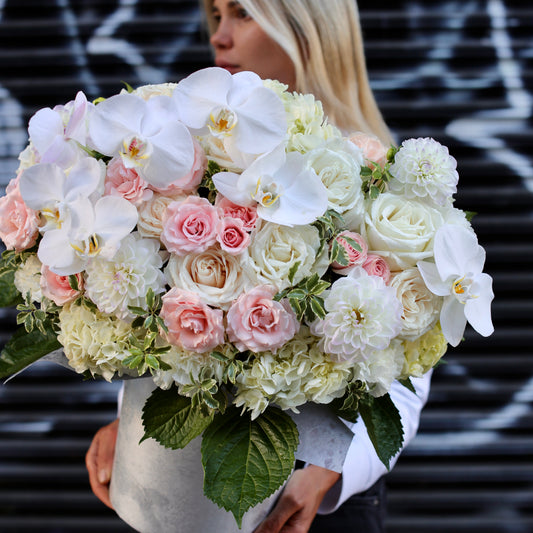 Elegant orchids and garden roses with dahlias bouquet, beautifully arranged in a boxed design for a refined and romantic look