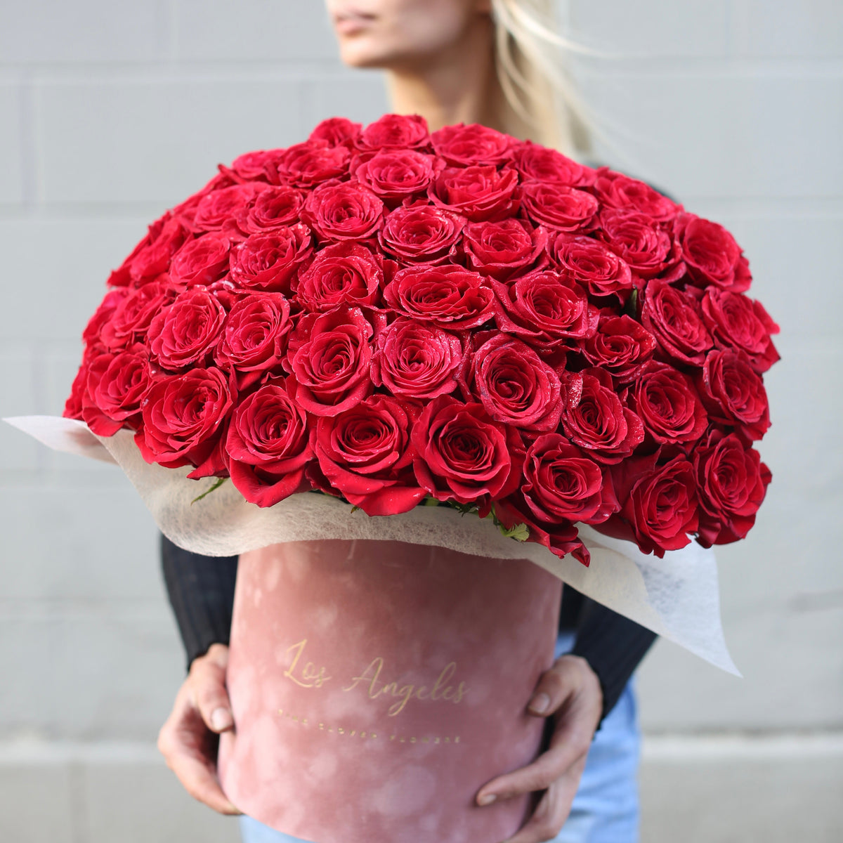 Luxurious velvet box filled with 50 fresh red roses, beautifully arranged for a romantic and elegant gifting experience
