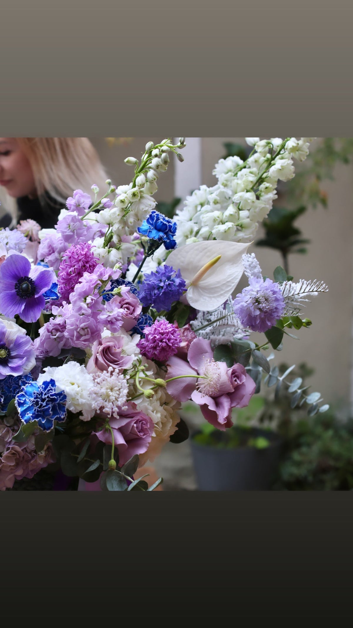 Handcrafted floral design with vibrant purple blooms, arranged in a sophisticated and artistic style