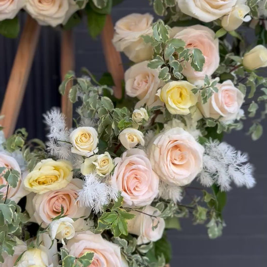 Vibrant floral arrangement featuring long-stemmed red roses and lush greenery