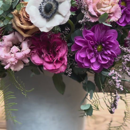 Handcrafted floral composition with dramatic anemones and complementary blooms, arranged in a refined aesthetic