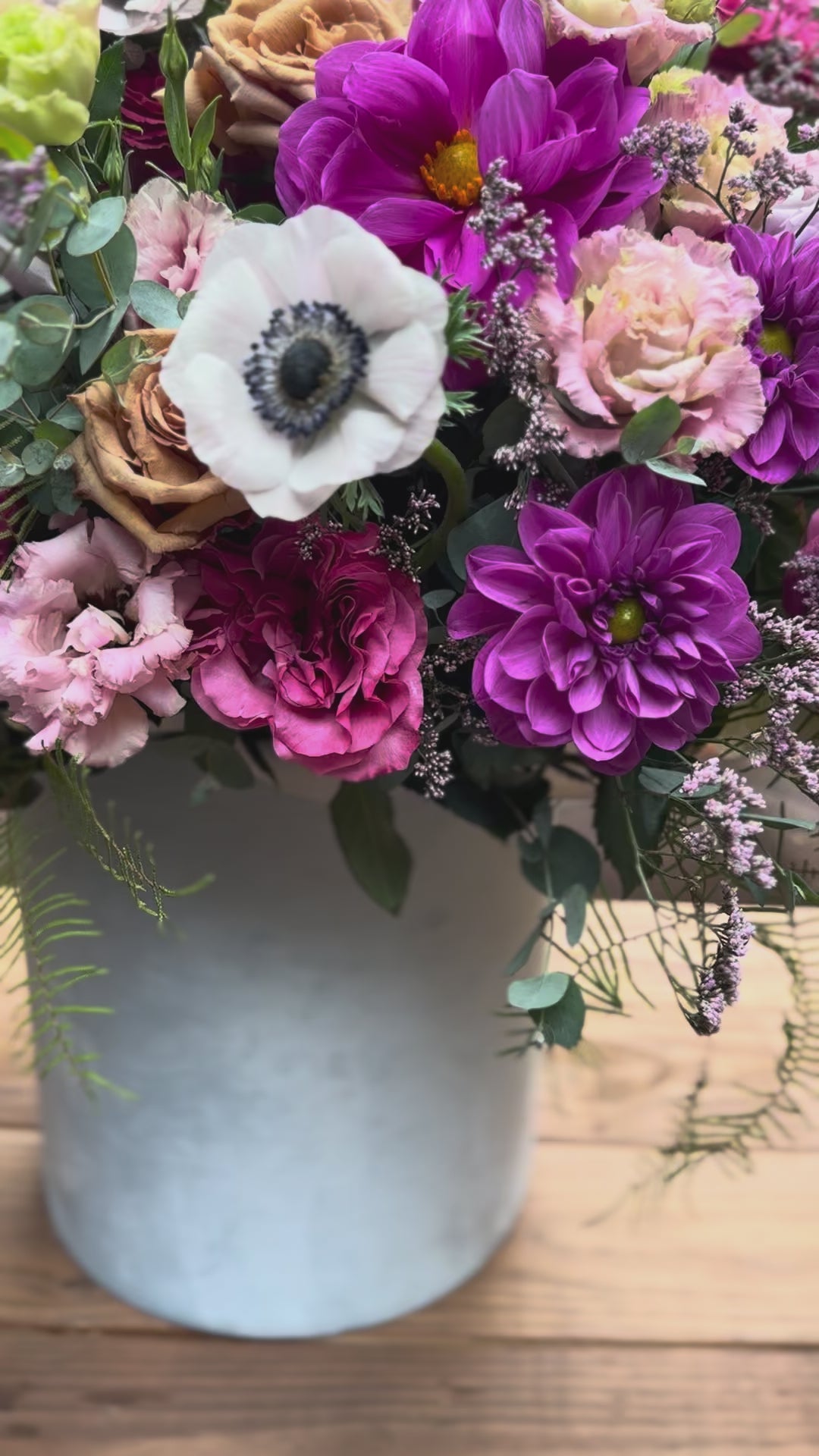 Handcrafted floral composition with dramatic anemones and complementary blooms, arranged in a refined aesthetic