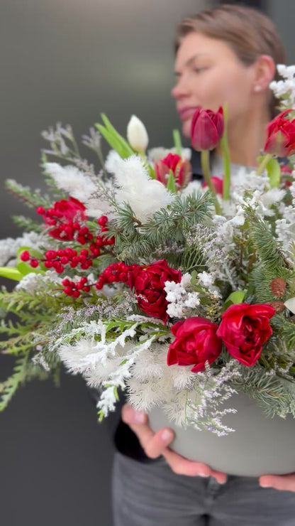 Handcrafted floral bouquet featuring white roses and lush greenery, ideal for winter celebrations